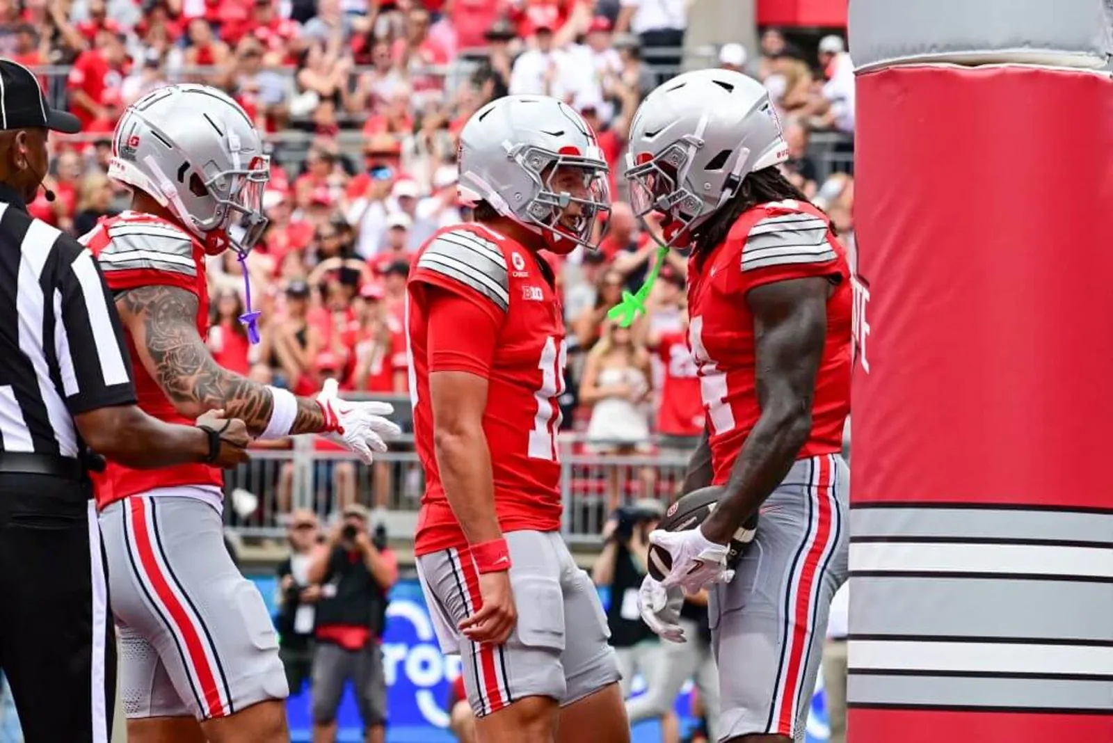 Julian Sayin and Jeremiah Smith face each other as they celebrate a touchdown.